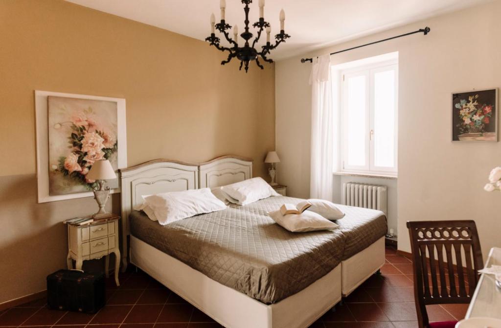 - une chambre avec un lit et un lustre dans l'établissement Casa Barbabuc, à Novello