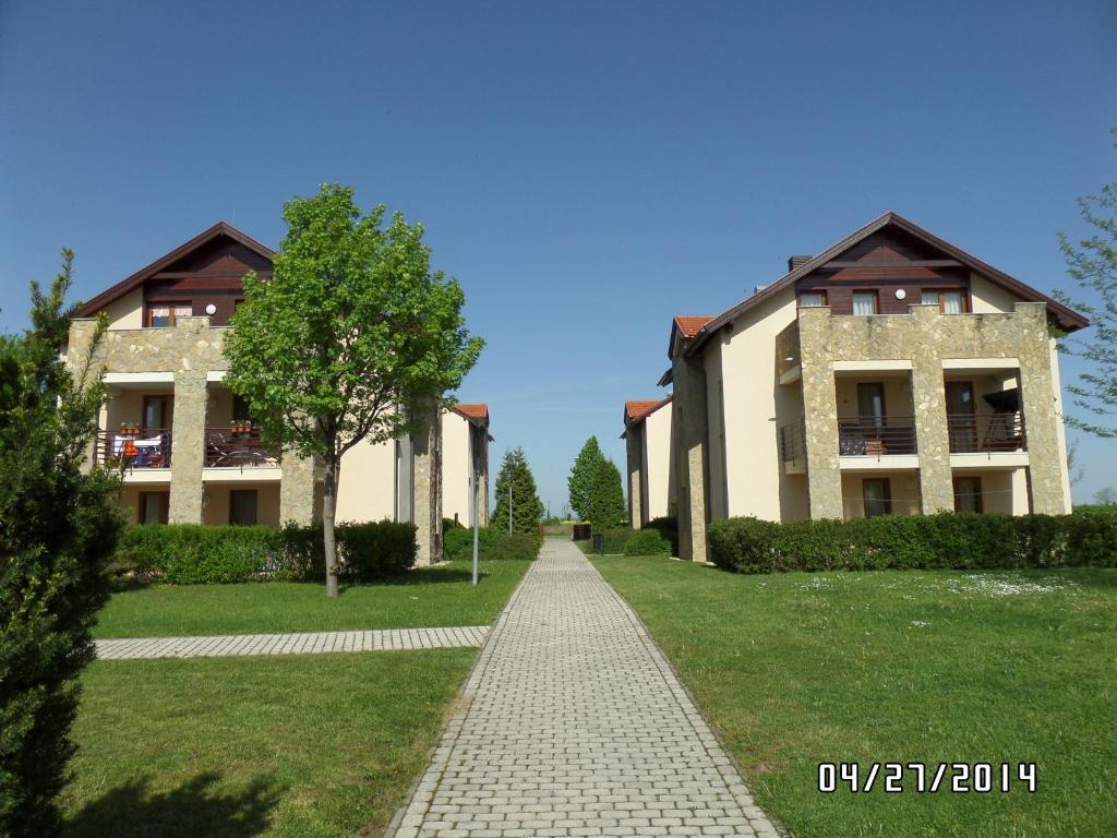 a building with a walkway in front of it at Nia Családi Apartman in Bük