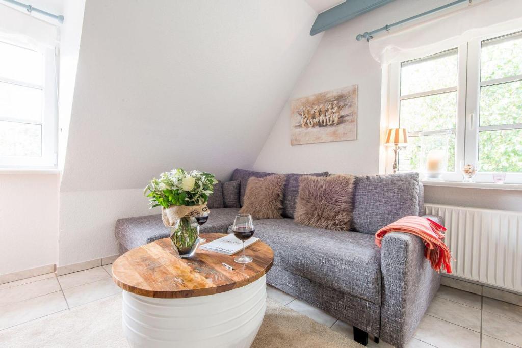 ein Wohnzimmer mit einem Sofa und einem Tisch in der Unterkunft Harderslebener Strasse 33b in Westerland