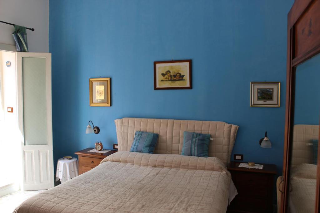 Postel nebo postele na pokoji v ubytování L'Isola Di Ortigia