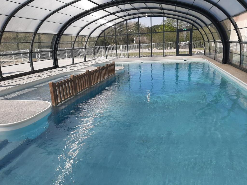 a large pool of blue water in a building at Stella Maris in Stella-Plage