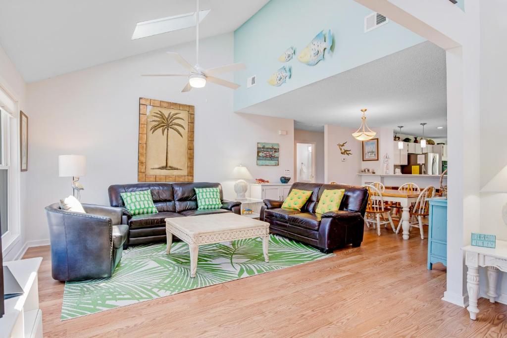 a living room with two leather couches and a table at Beachside Drive 14 in Isle of Palms