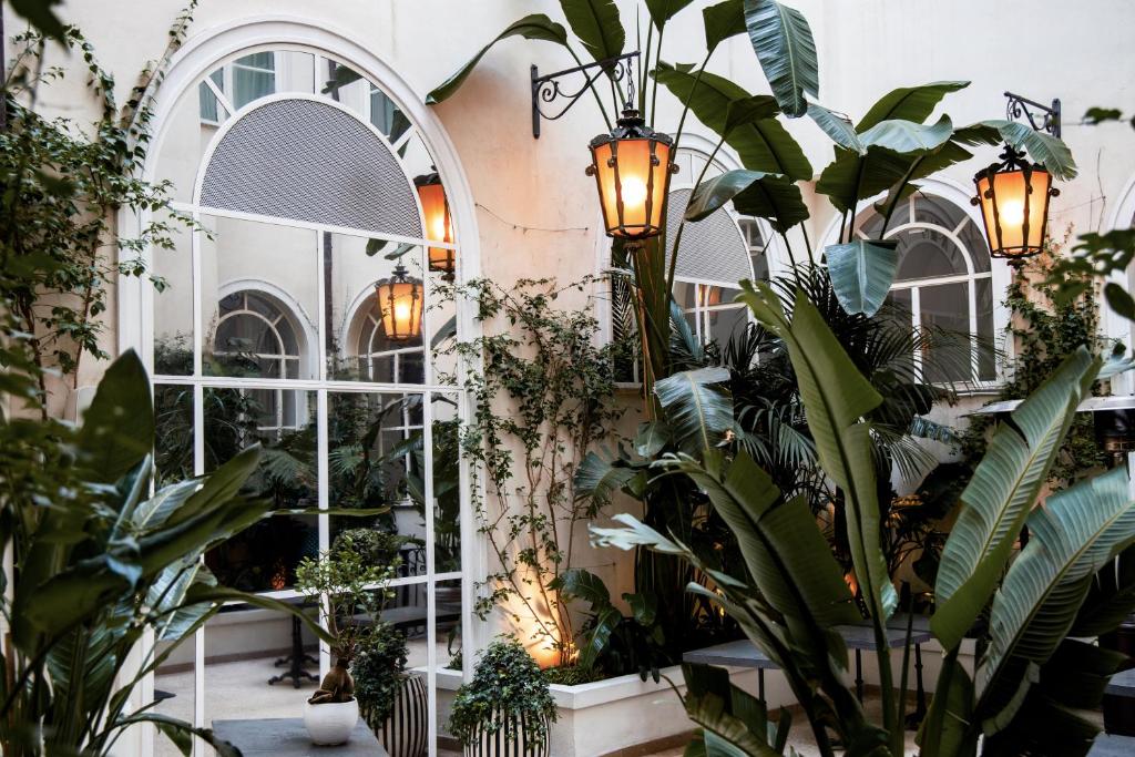 a room filled with lots of plants and lights at Hotel Vilòn - Small Luxury Hotels of the World in Rome
