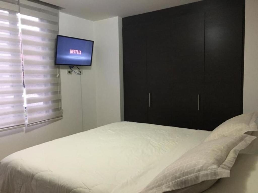 Postel nebo postele na pokoji v ubytování Misuitehotel La Carolina Quito