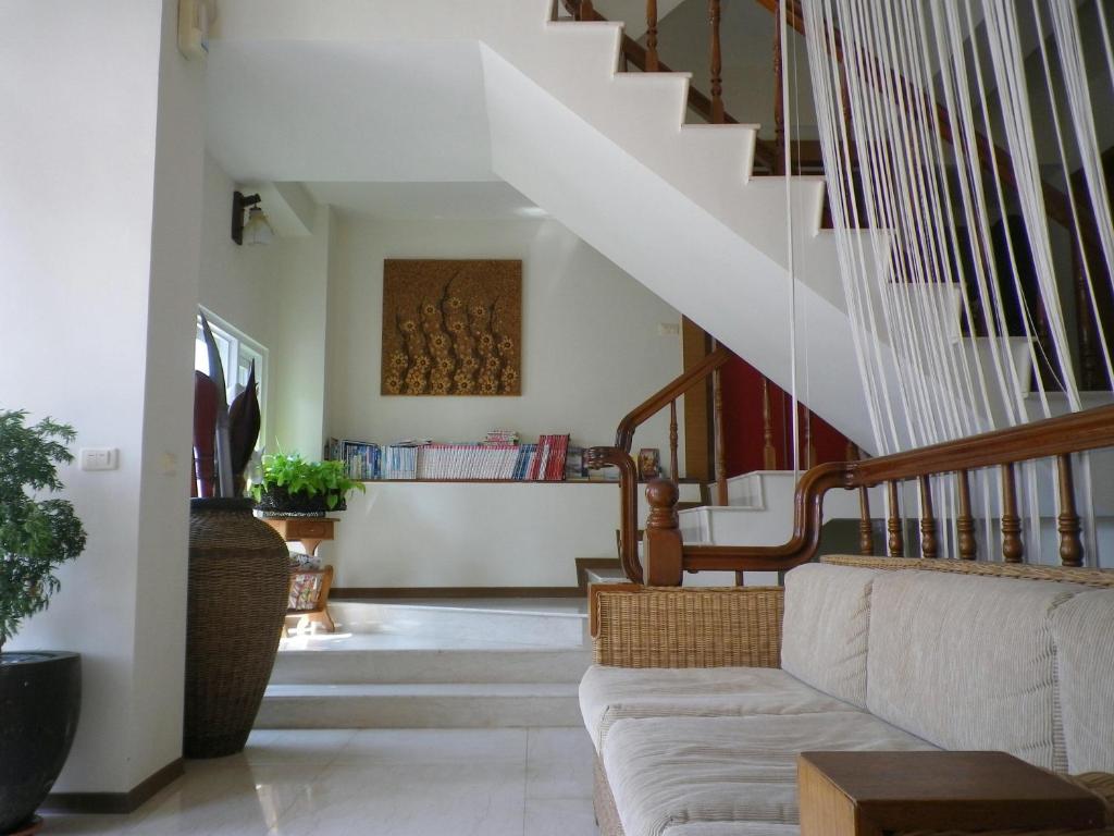 a living room with a couch and stairs at Mamalulu Hostel in Kenting
