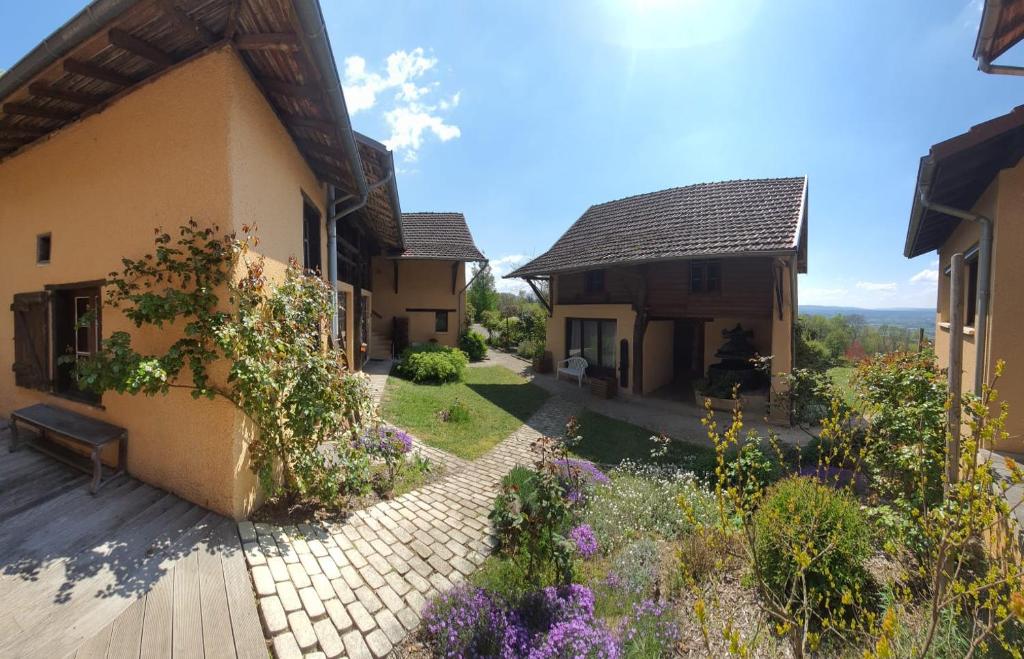 a courtyard of a house with a garden at La Parenthèse in Saint-Genix-sur-Guiers