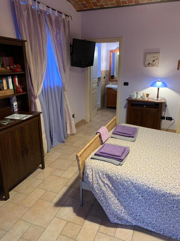 Postel nebo postele na pokoji v ubytování B&B Cascina Martinetta