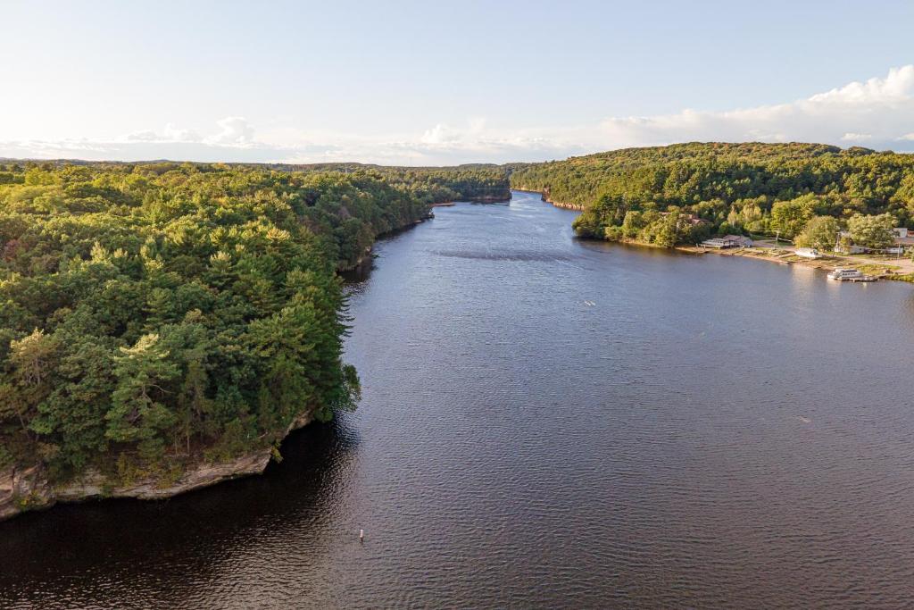 an aerial view of a river with trees on both sides at White Rose Inns & Motel in Wisconsin Dells