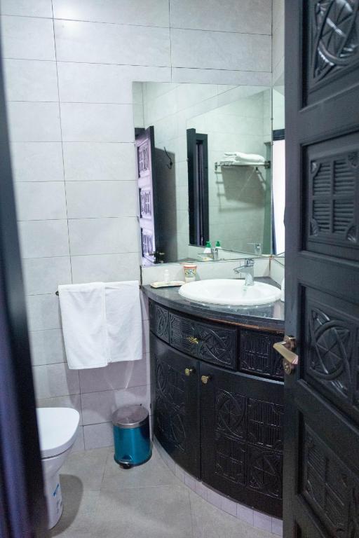 a bathroom with a sink and a toilet and a mirror at Dar Zayane in Khenifra