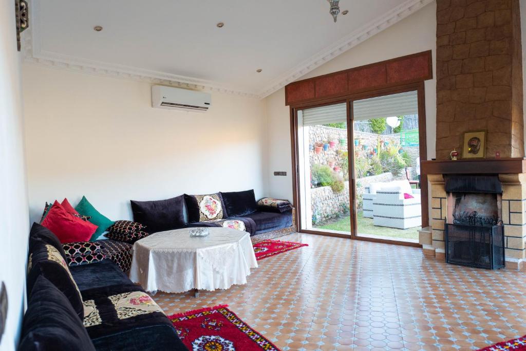 a living room with a couch and a table at Dar Zayane in Khenifra