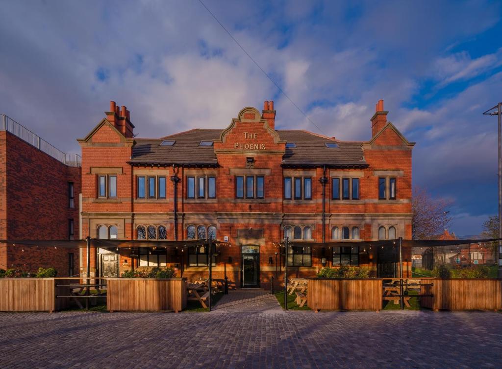 a large brick building in front of a building at Phoenix Hotel Liverpool in Liverpool