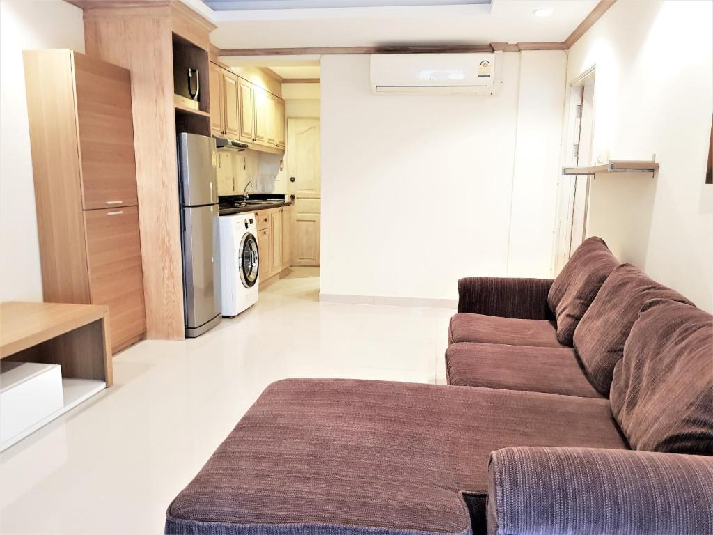 a living room with a couch and a kitchen at Sea view apartment Jomtien beach condominium 12th Floor in Jomtien Beach