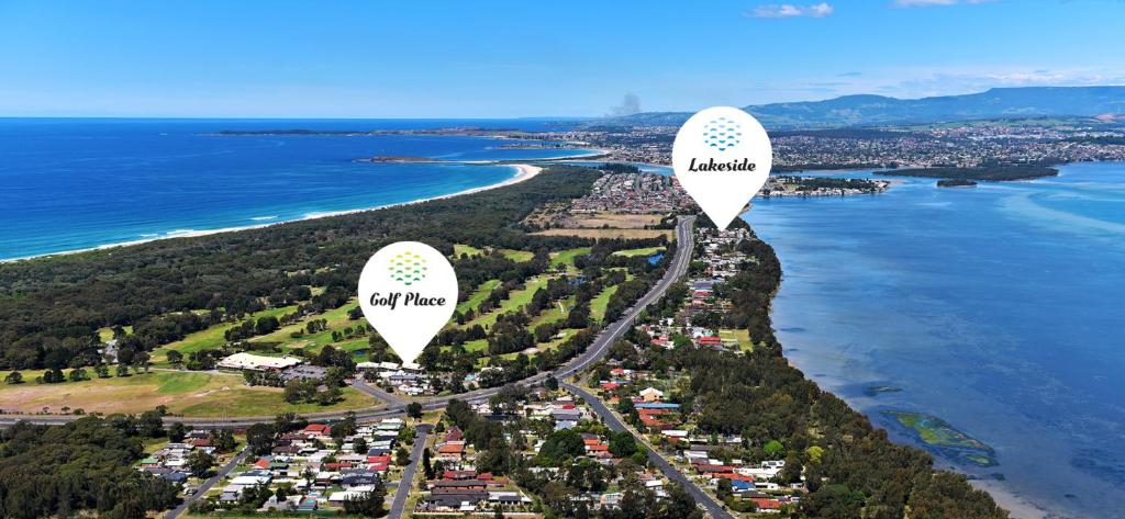 two hot air balloons are flying over a beach at Lakeside Inn Wollongong in Wollongong