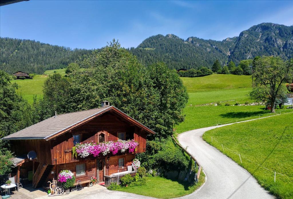 a house with flowers on the side of a road at Wörglerhof in Alpbach