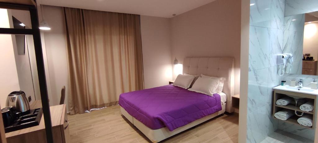 Postel nebo postele na pokoji v ubytování Sonia Hotel & Suites