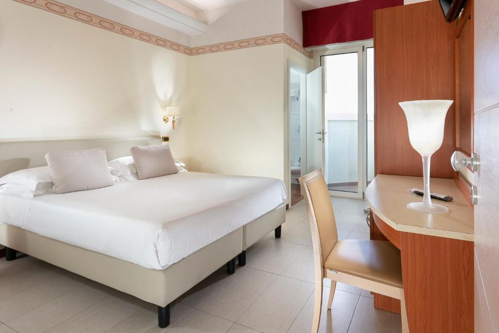 Postel nebo postele na pokoji v ubytování Hotel Bikini