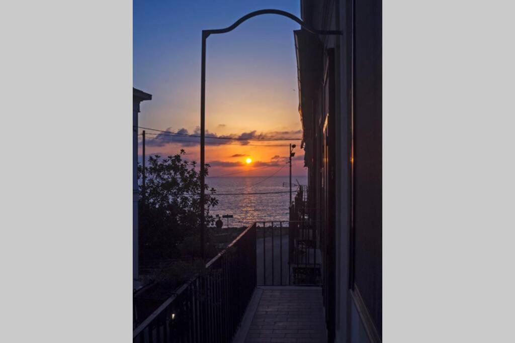 a sunset seen through a window of a building at Relax on the Sea in Pizzo