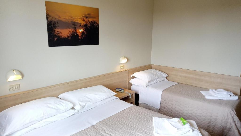 Postel nebo postele na pokoji v ubytování Hotel President
