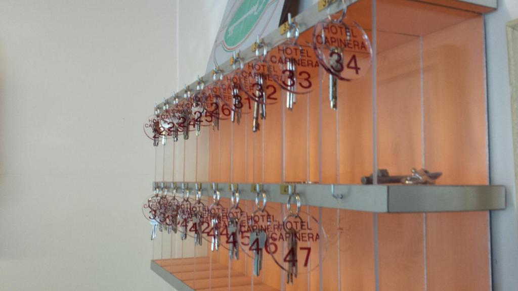 a row of toothbrushes hanging on a wall at Hotel Garnì Capinera in Garda