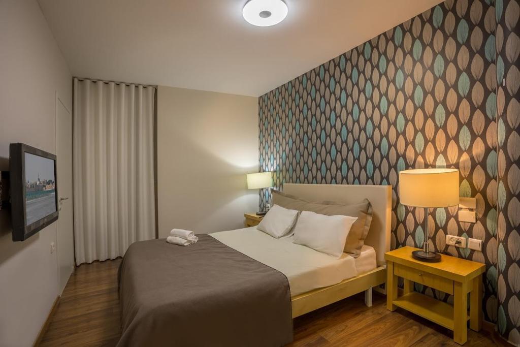Postel nebo postele na pokoji v ubytování Acco Beach Hotel