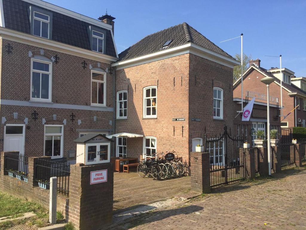 uma casa de tijolos com um telefone público em frente em B&B Appartementen Smedery em Nijmegen