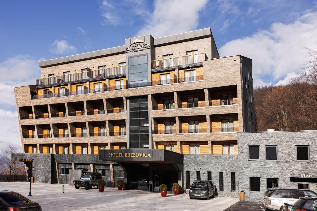 a building with cars parked in front of it at Brezovica Hotel & SPA in Brezovica