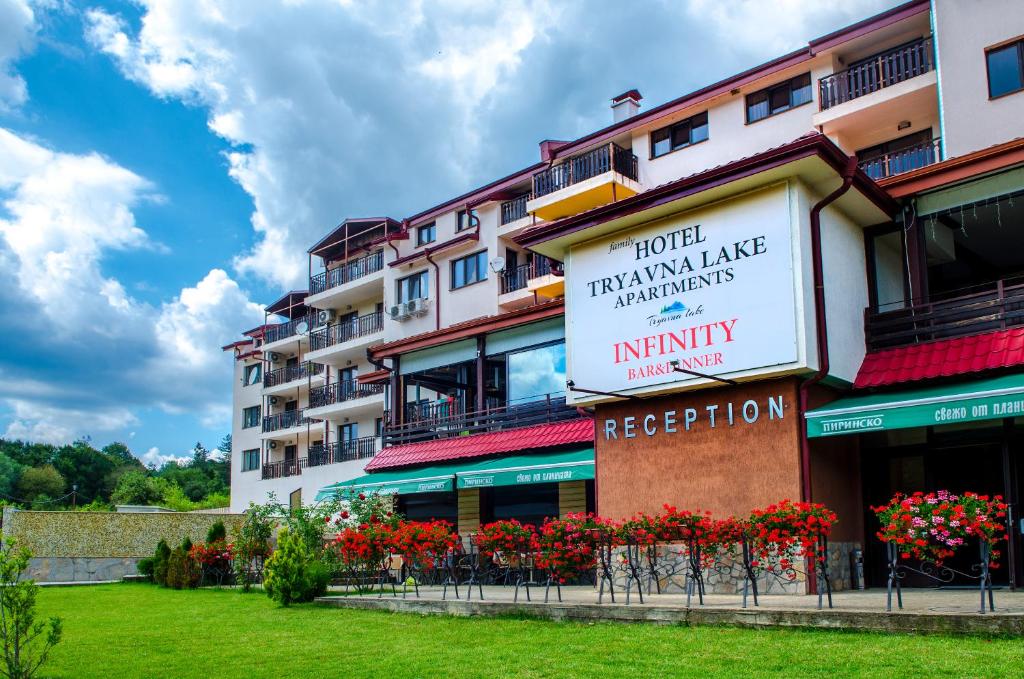 a building with a sign for a hotel at апартаменти Tryavna lake in Tryavna