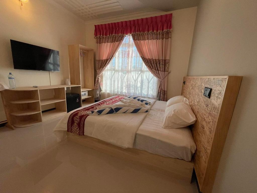 Postel nebo postele na pokoji v ubytování Ocean Waves Inn