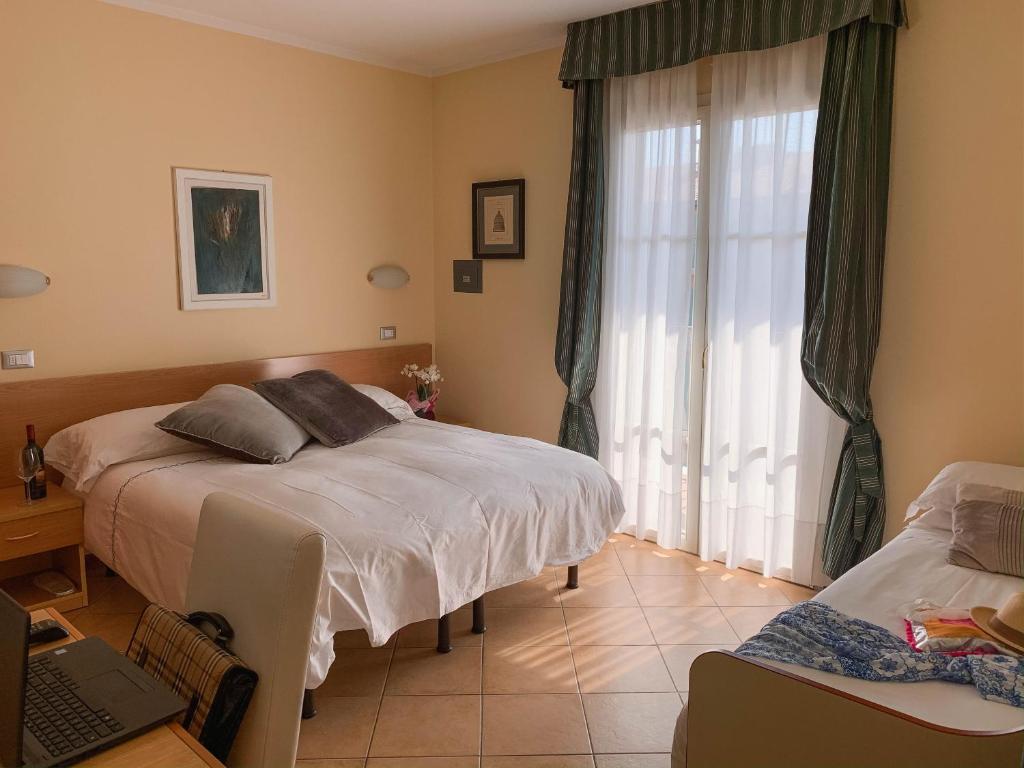Postel nebo postele na pokoji v ubytování Hotel La Bitta
