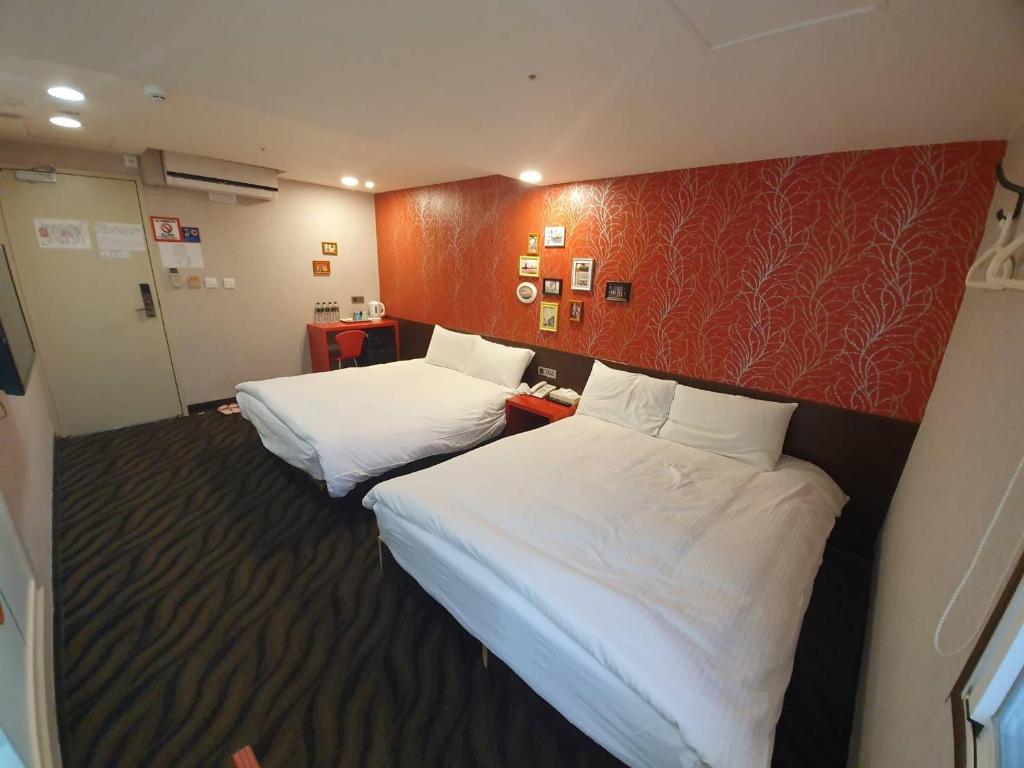 Postel nebo postele na pokoji v ubytování Funny Ximen Hotel