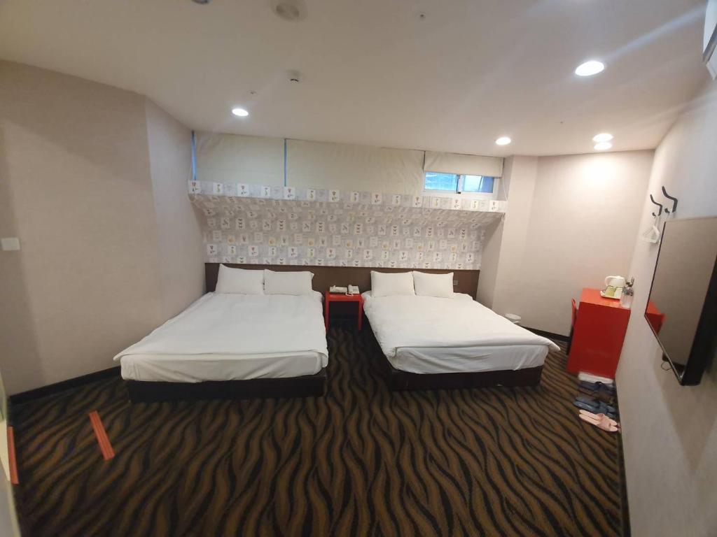 Postel nebo postele na pokoji v ubytování Funny Ximen Hotel