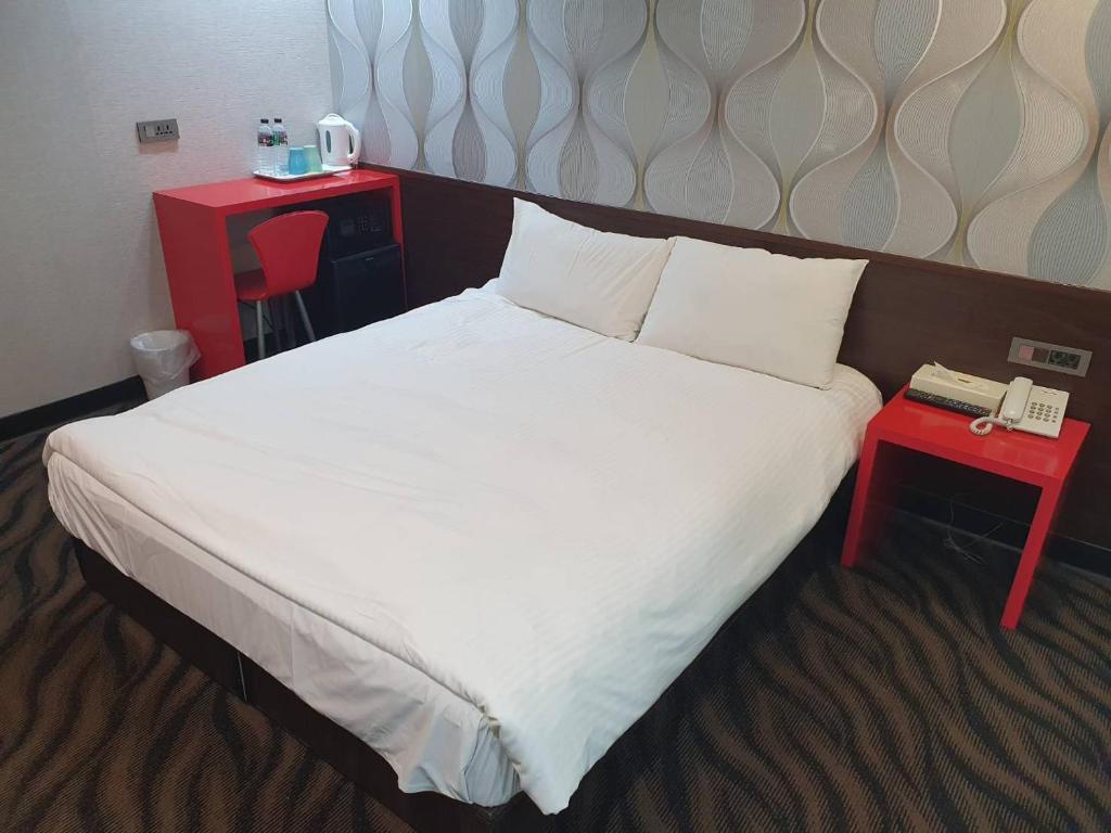 Postel nebo postele na pokoji v ubytování Funny Ximen Hotel