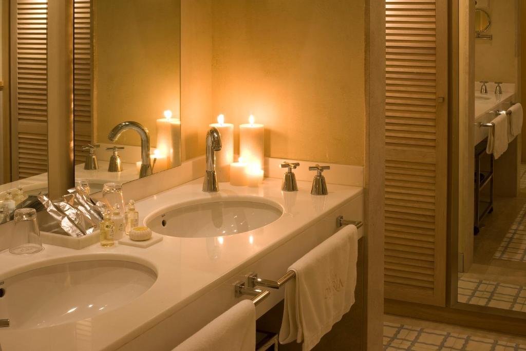 a bathroom with a sink with candles and towels at Villa Oniria in Granada