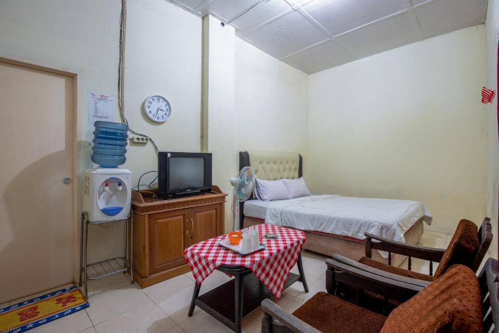 Postel nebo postele na pokoji v ubytování Hotel Jogja Bukittinggi