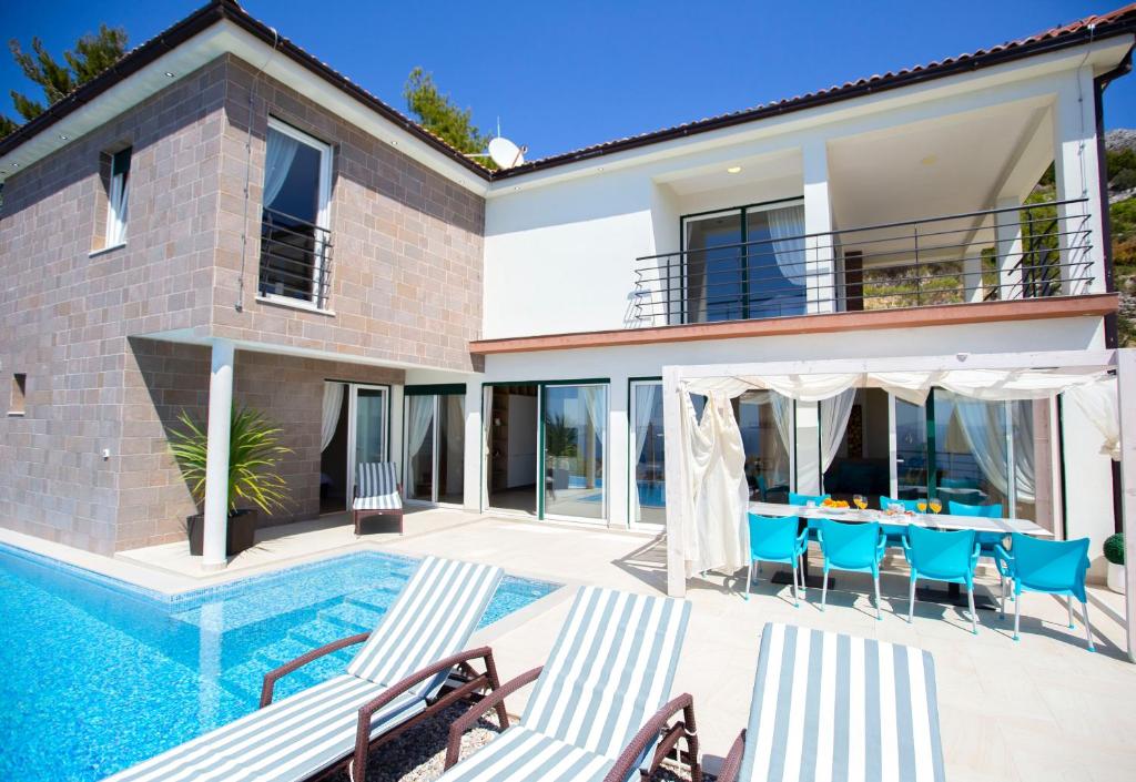 a villa with a swimming pool and a house at Royal Villa in Podstrana