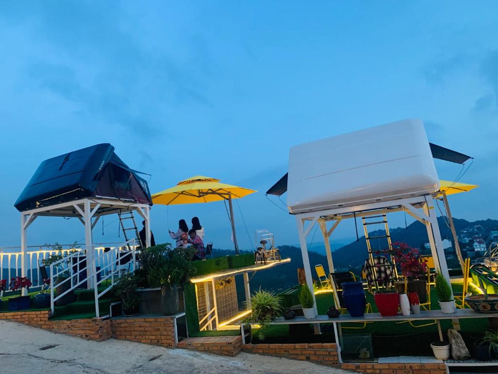 a restaurant with two umbrellas and a view of the ocean at UNID Home in Da Lat