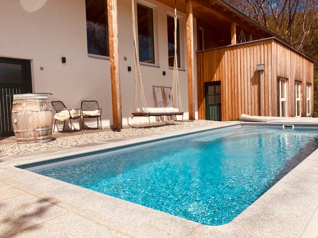 a swimming pool in front of a house at Die Mayerei in Kitzeck im Sausal