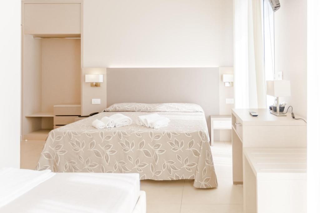 Postel nebo postele na pokoji v ubytování Hotel Bagli