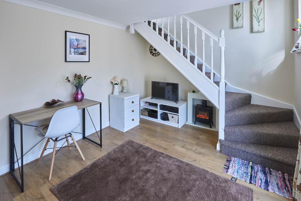 een woonkamer met een bureau en een trap bij Host & Stay - Beatrice Little Duckling in Middlesbrough
