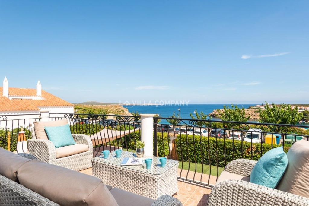 a balcony with chairs and a view of the ocean at Villa BELLAVISTA in Arenal d'en Castell