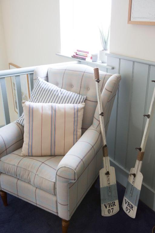 a living room with a white couch and two axes at Seacroft in Holyhead