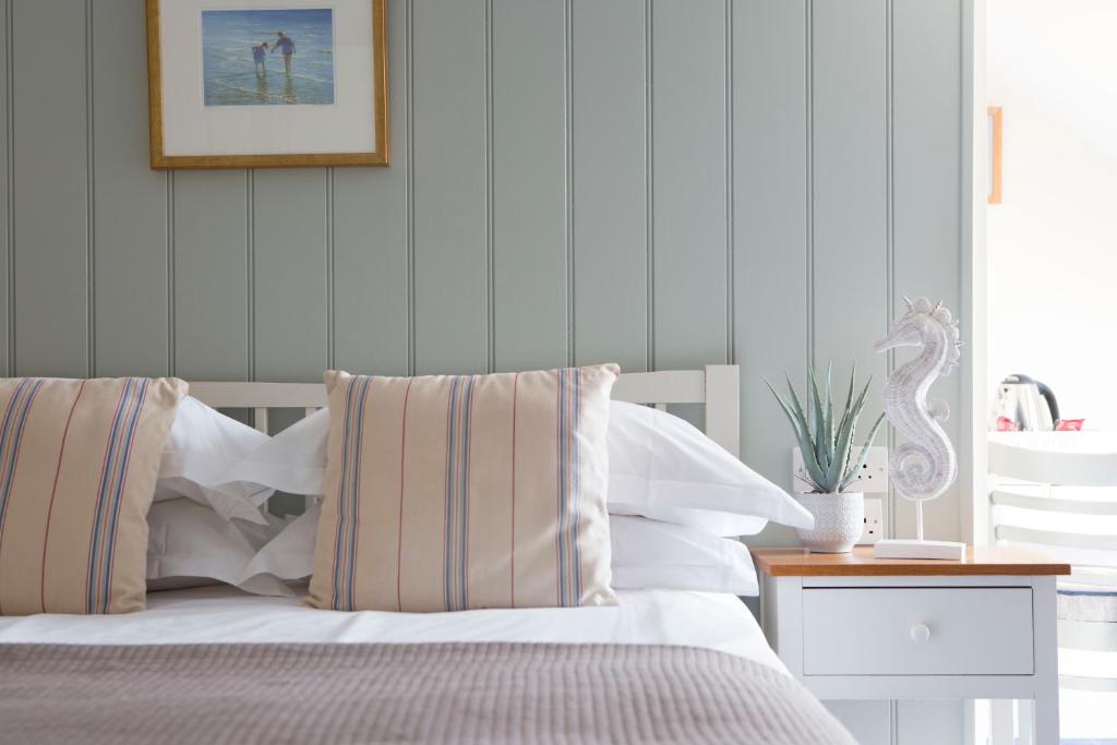 a bedroom with a bed and a picture on the wall at Seacroft in Holyhead