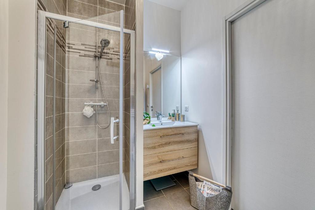 uma casa de banho com um chuveiro e um lavatório. em LE TRESUM - Appartement + Garage - V-RENT em Annecy