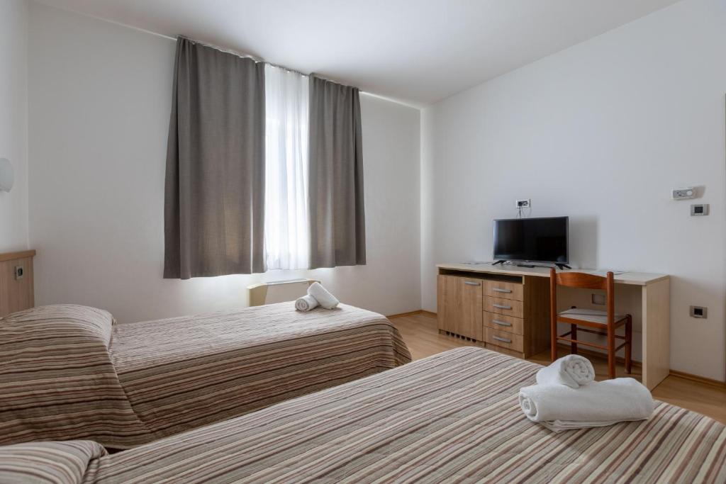 Postel nebo postele na pokoji v ubytování Hotel Porto