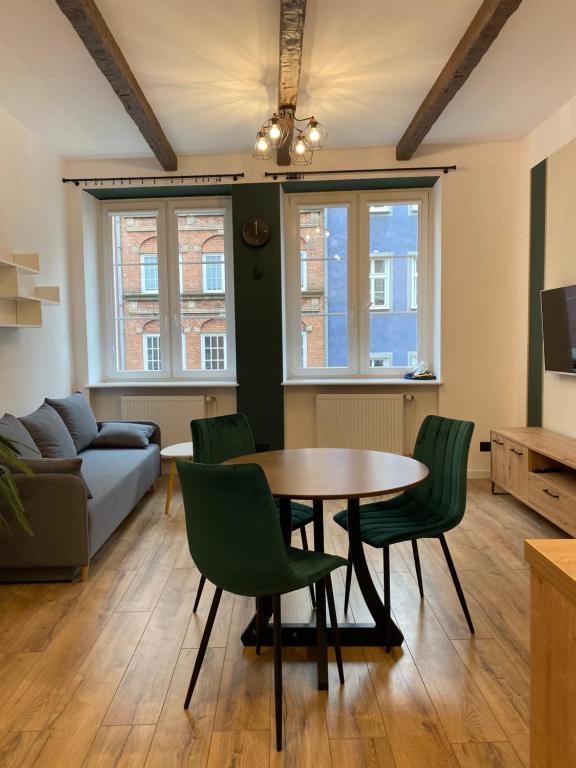 a living room with a table and chairs and a couch at Apartament Gdańsk Centrum Old Town in Gdańsk