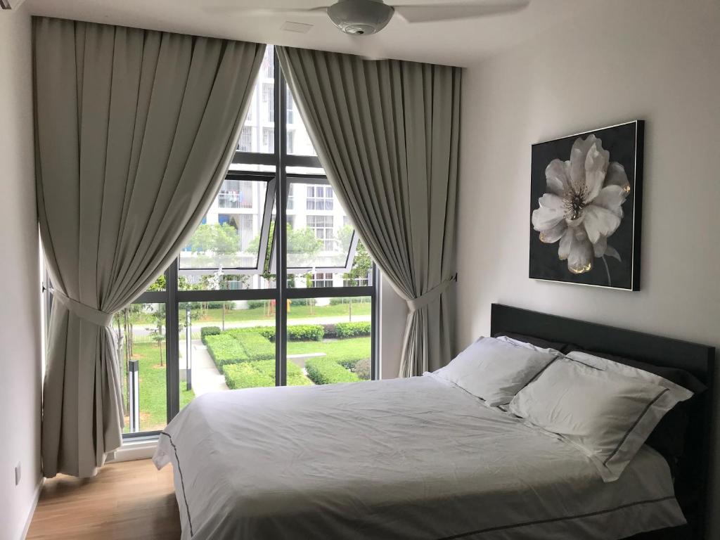 a bedroom with a bed and a large window at Cyberjaya amazing view Fully furnished 3 bedroom in Cyberjaya