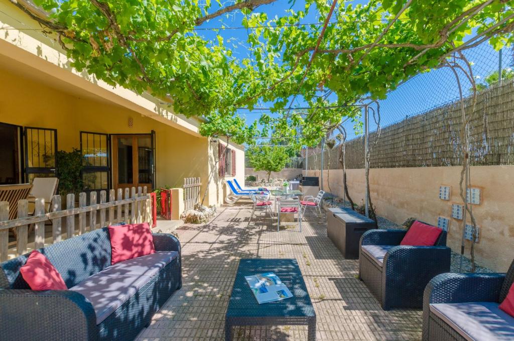 eine Terrasse mit Sofas, einem Tisch und Stühlen in der Unterkunft YourHouse Sa Raconada in Algaida