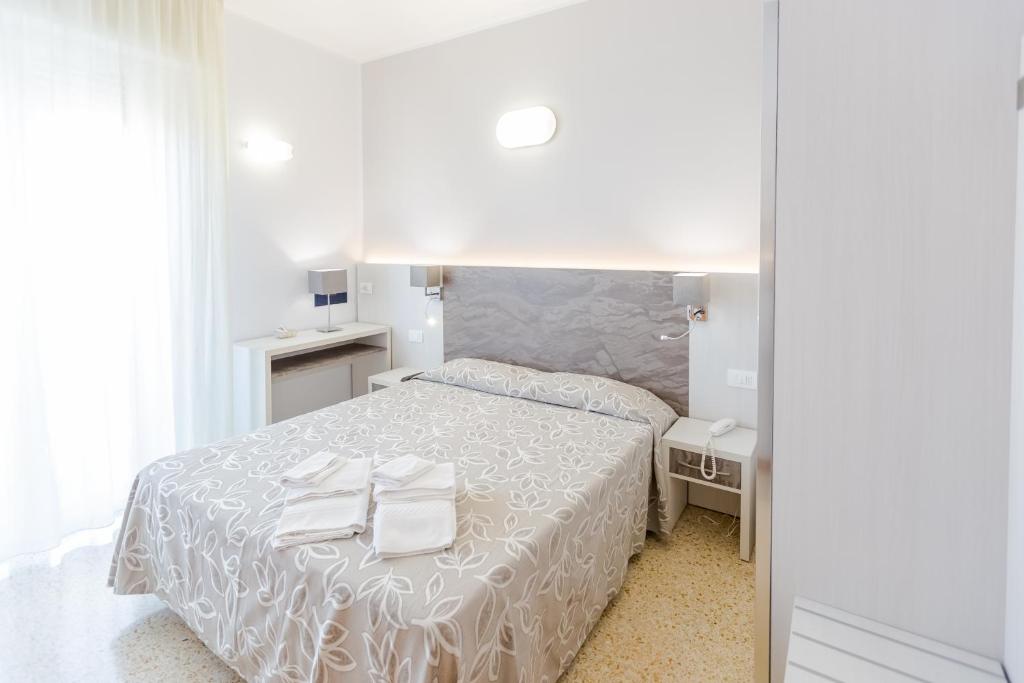 Postel nebo postele na pokoji v ubytování Hotel Bagli