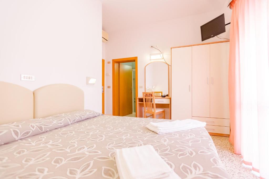 Postel nebo postele na pokoji v ubytování Hotel Bagli