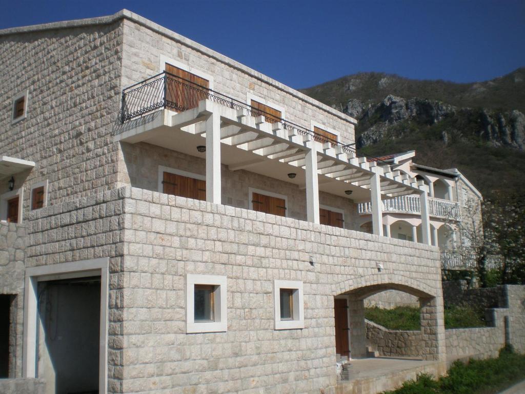 a building with a balcony on top of it at Villa Lidija in Budva